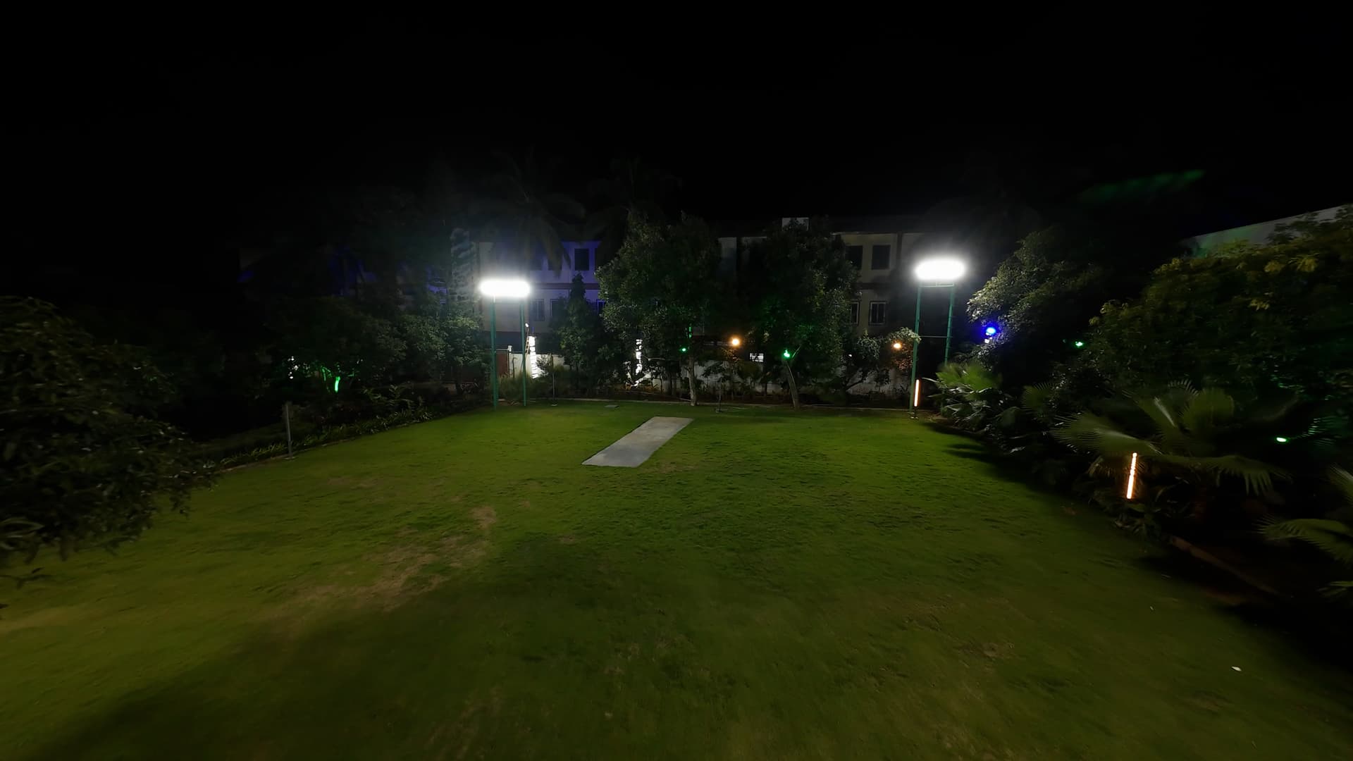 Night view of our floodlit cricket ground with a proper pitch.