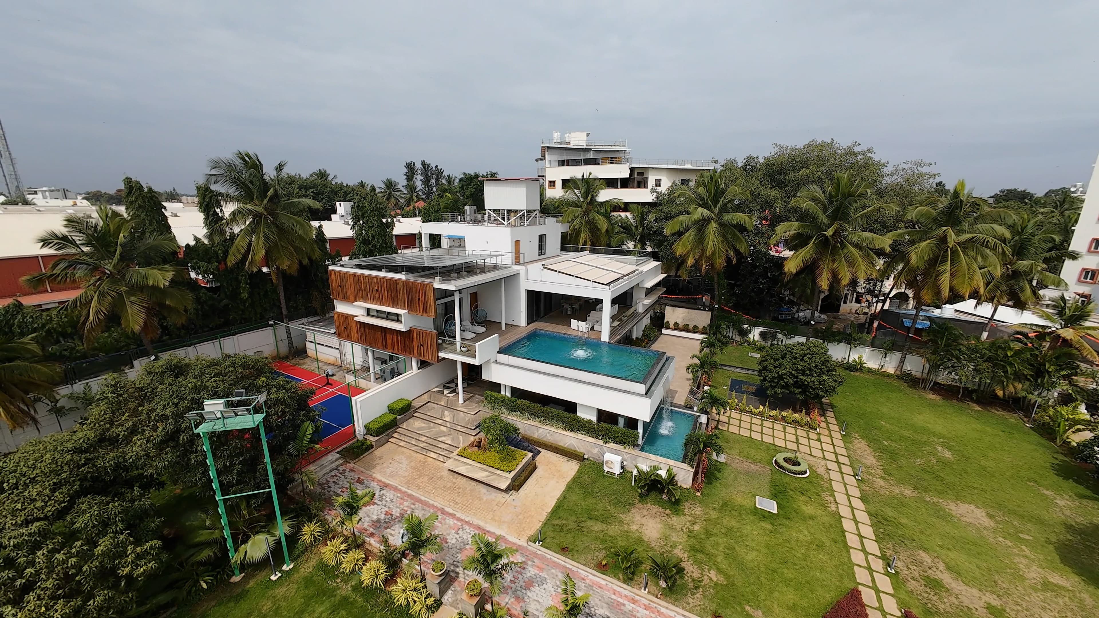 Property aerial showing lawn and court